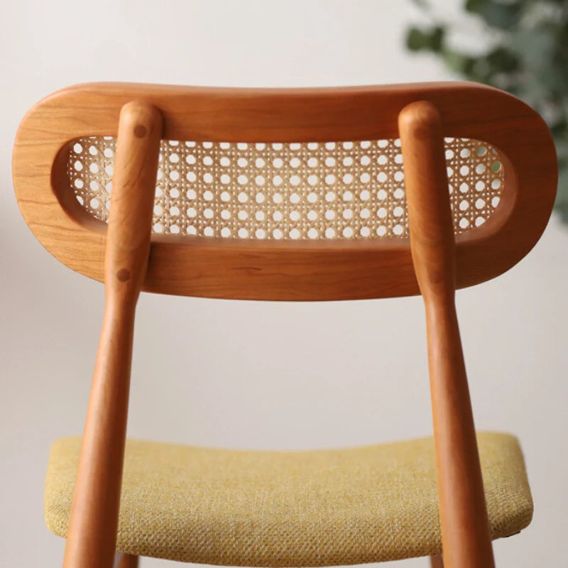 A Rattan Dining Chair featuring a Curved Backrest (Back View)