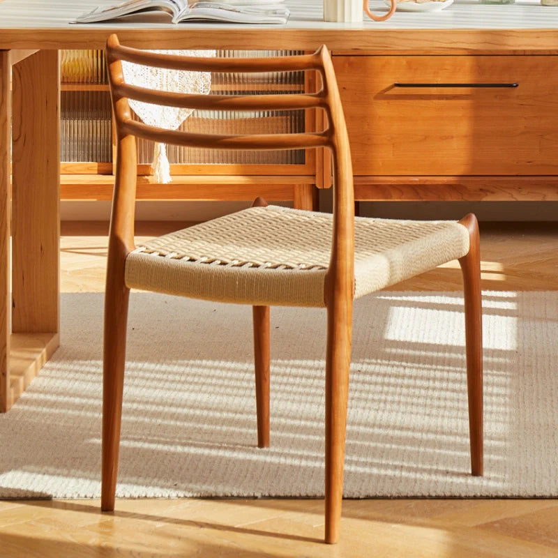 The Back View of a Wood Dining Chair in Dining Room Setting 