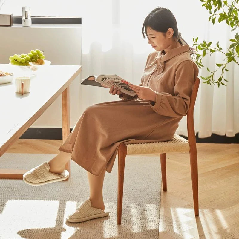 A Wooden Dining Chair Supporting The Back