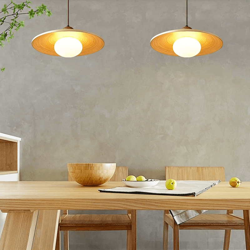 Kitchen island pendant light illuminating a traditional dining area