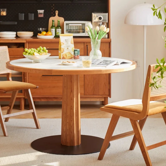 A Wood Pedestal Dining Table with White Stone Top and Dining Chairs in a Modern Living Room Setting