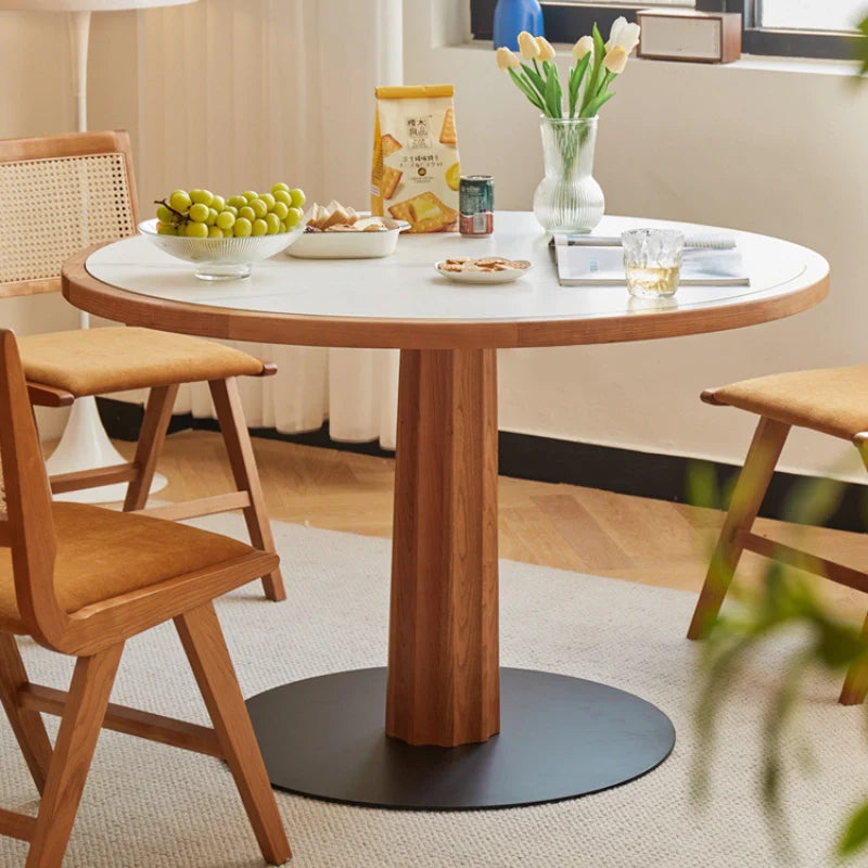 A Wood Pedestal Dining Table with White Stone Top and Matching Dining Chairs