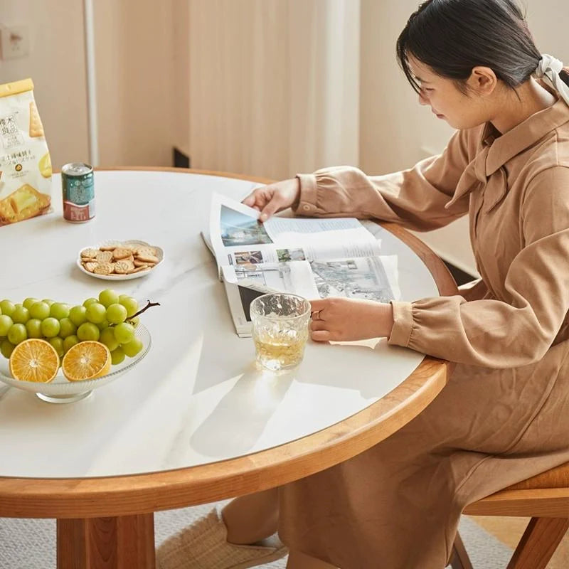 a round wood pedestal dining table displaying some eatables