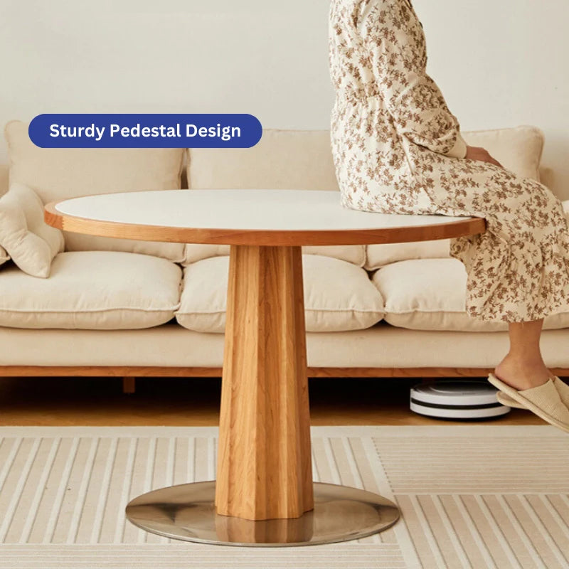 A Wood Pedestal Dining Table with White Stone Top in a Modern Living Room Setting