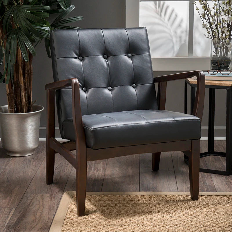 a black leather accent chair in a living room setting