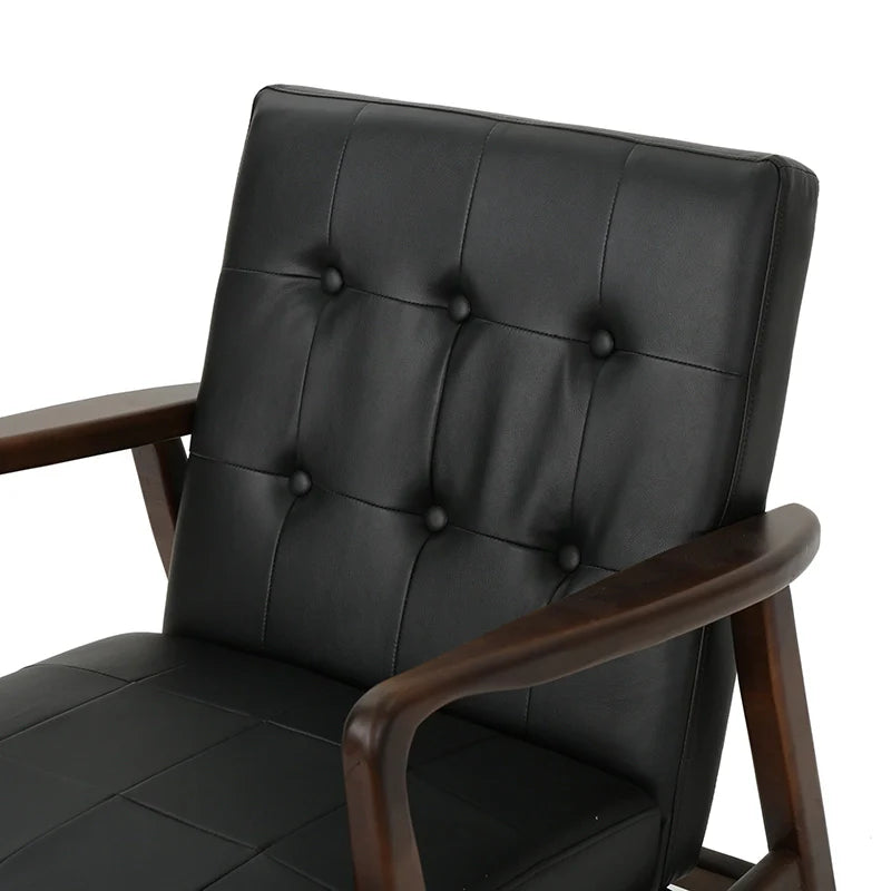 a close-up view of a black leather accent chair