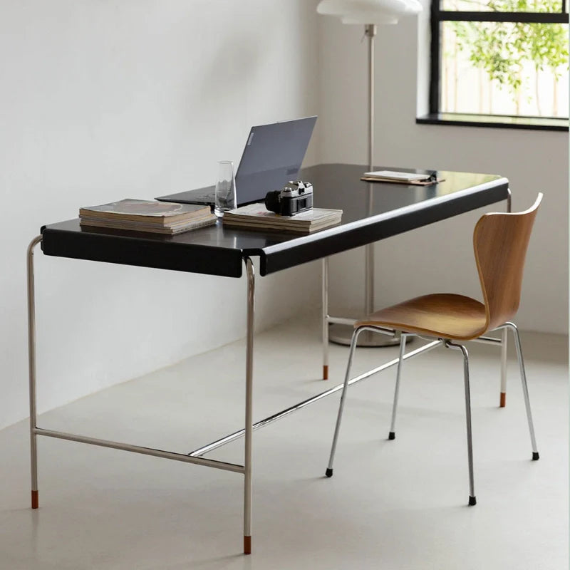 a mid-century modern desk with stainless steel legs 