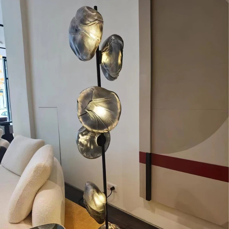 a midcentury modern floor lamp with black frame and smoky gray shade