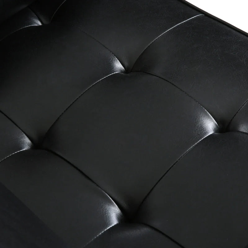 The tuftefd detailing of a black leather accent chair 