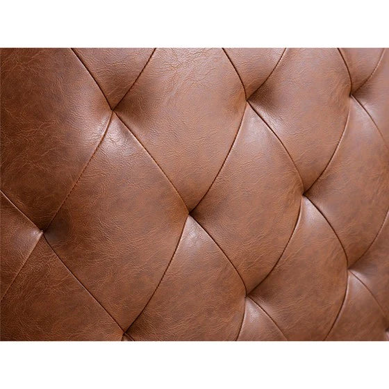 the tufted detailing of a leather accent chair