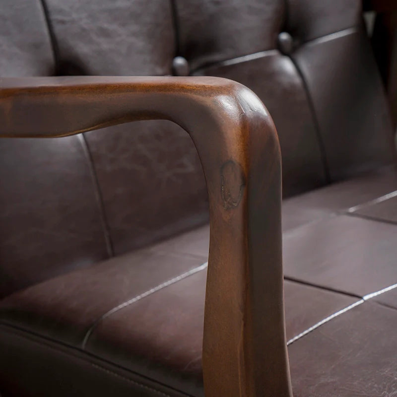 the armrest of a leather accent chair