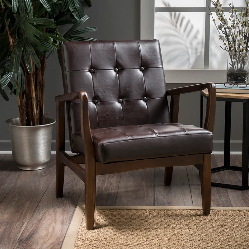 a brown leather accent chair in a living room setting