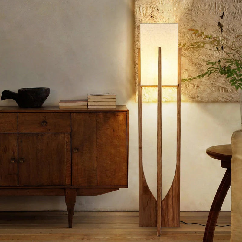 Mid Century Modern floor lamp in natural wood color beautifully illuminating a living room, stationed beside a sideboard