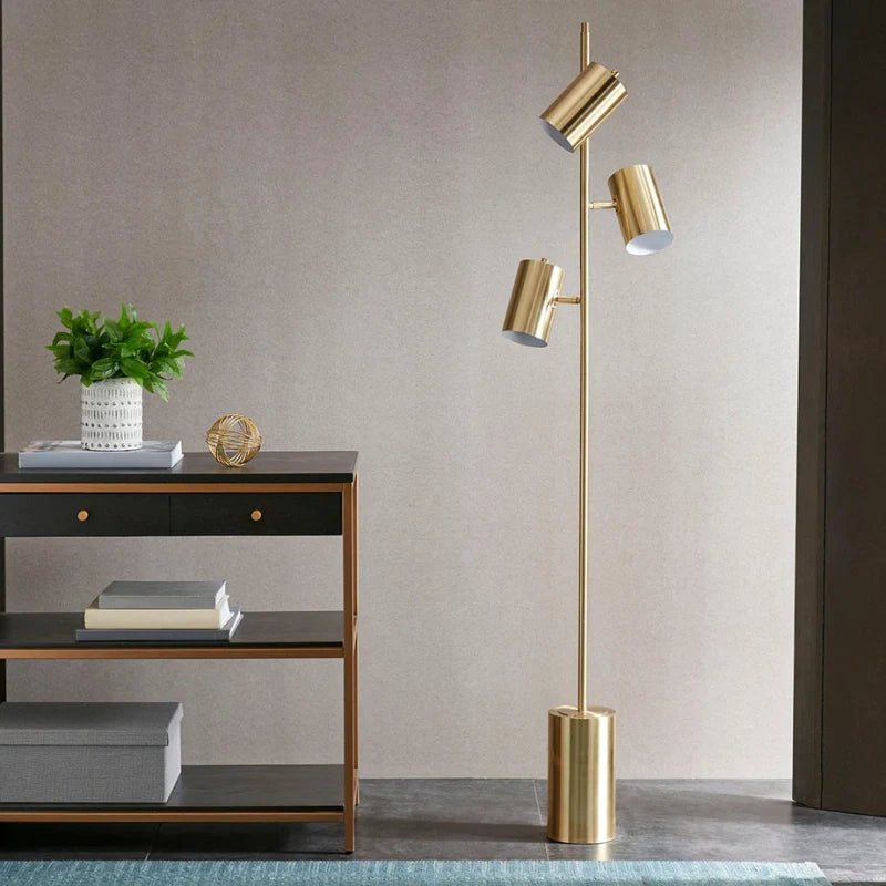 Modern Gold Floor Lamb with its 3 adjustable lights turned off over a study desk