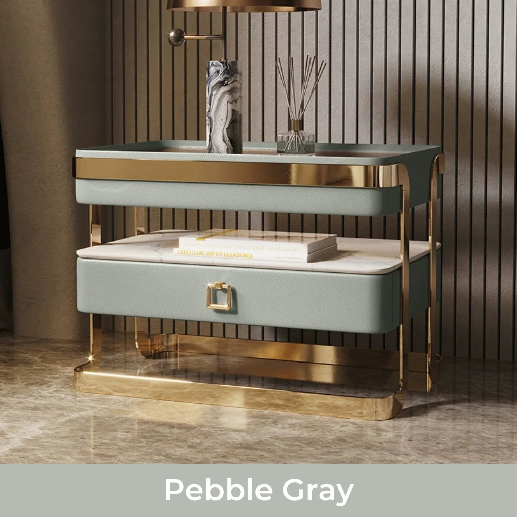 An image of modern nightstand with a sleek tempered glass top, PU leather drawer, gold metal frame, and open sintered stone shelf, showcasing a stylish and functional design perfect for bedside table ideas and contemporary bedroom aesthetics.