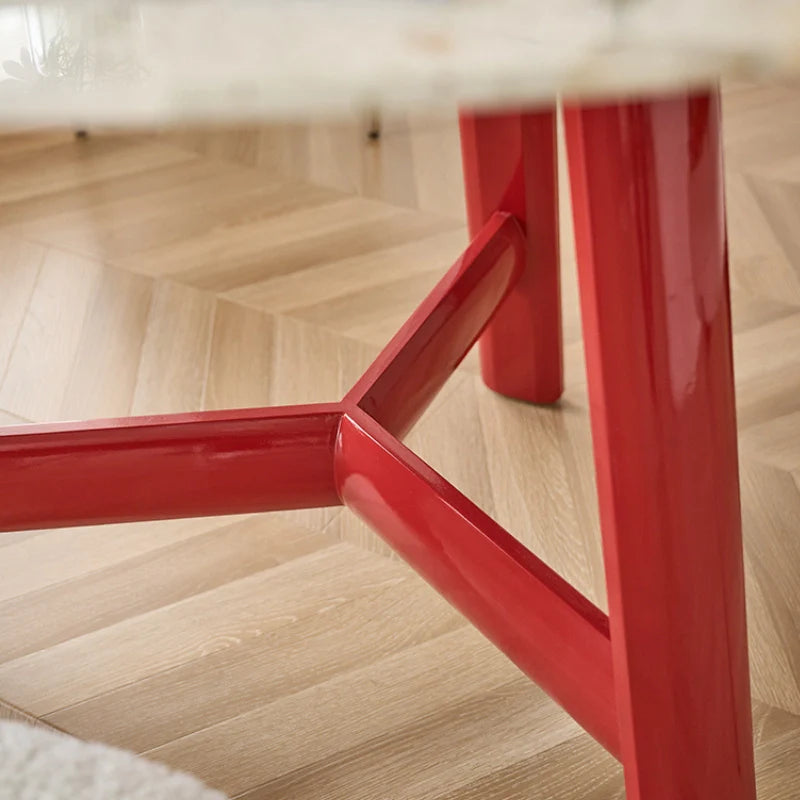 a wood dining table with a red base