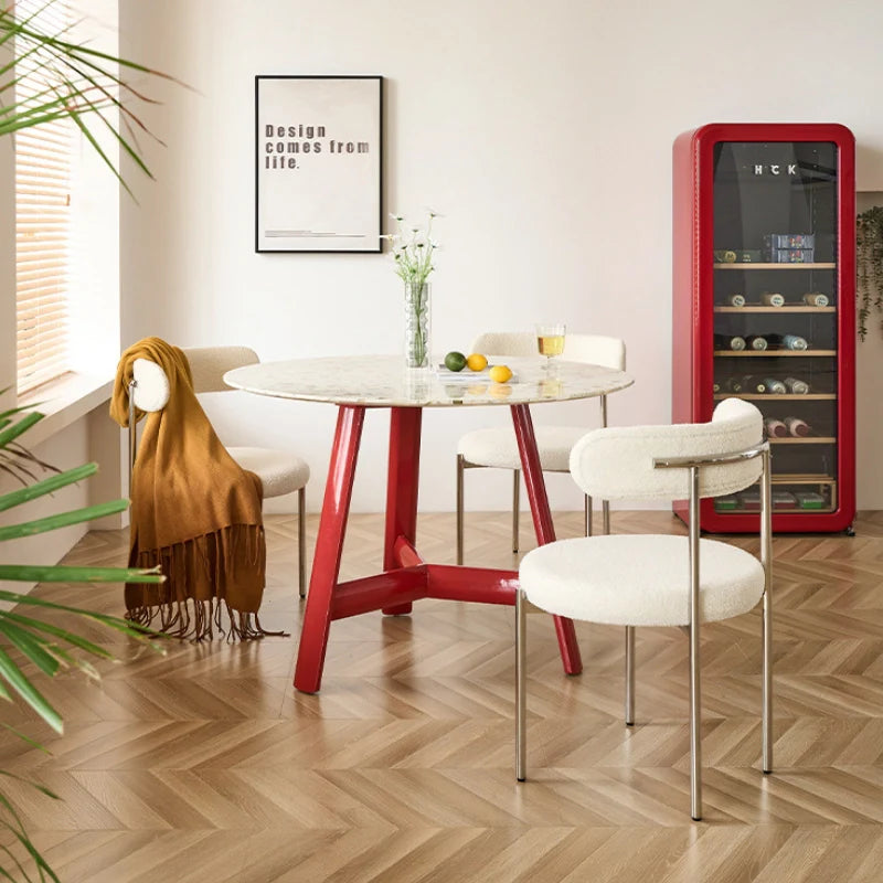 a wood dining table with a white table top and a red base