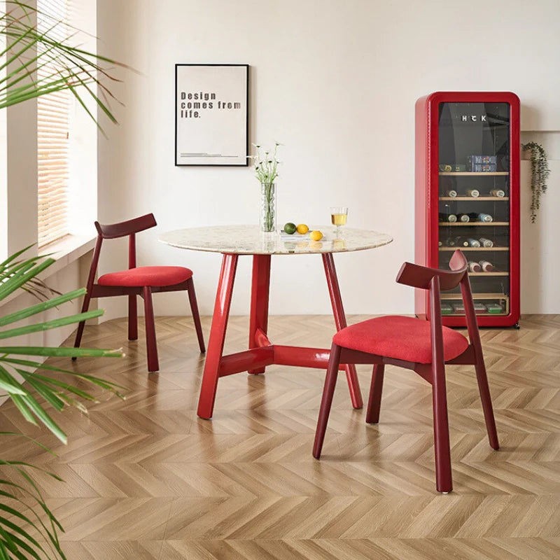 a wood dining table with 2 matching dining chairs in a modern setting