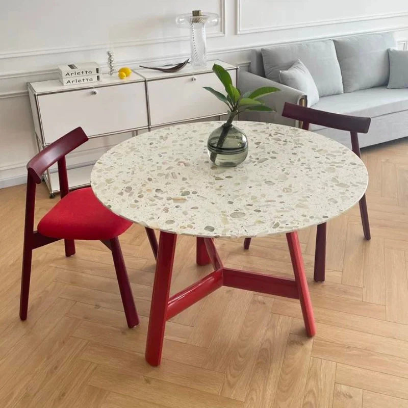 a wood dining table with a white table top and a red base