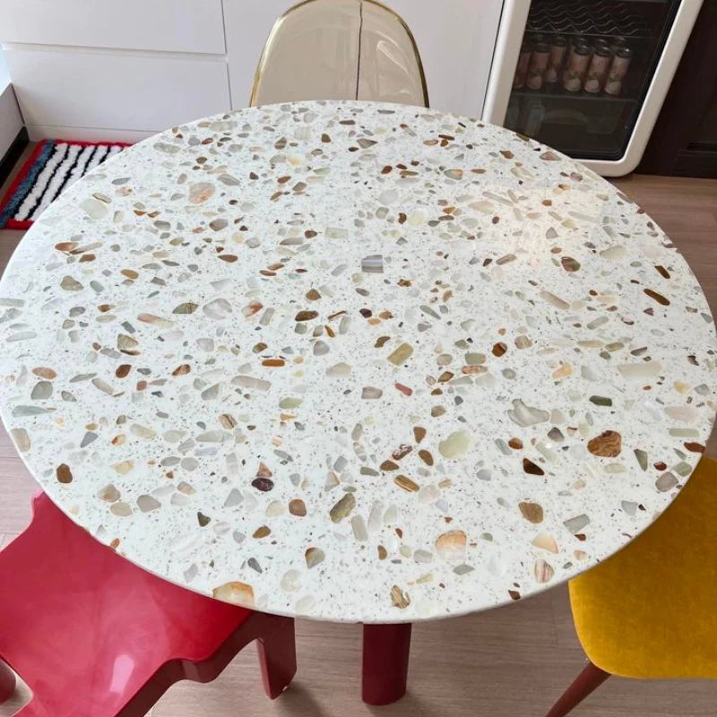 a wood dining table with stone top