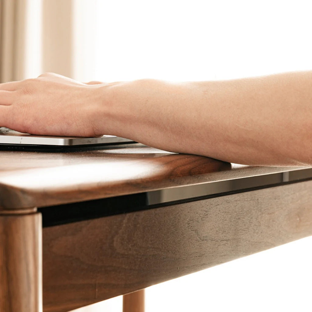 A natural walnut wood desk with a timeless design and plenty of drawer space for daily essentials.