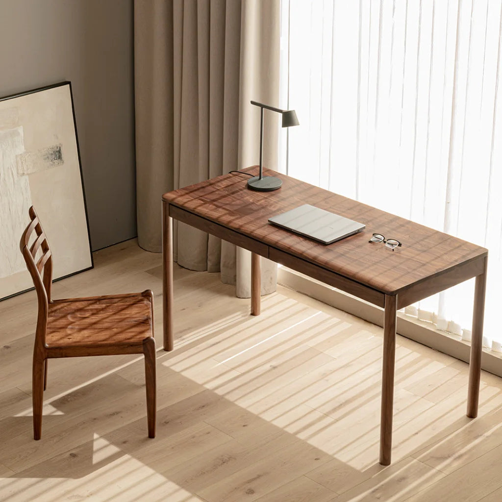 A walnut wood desk with a natural finish and ample drawer space for a clutter-free workspace.