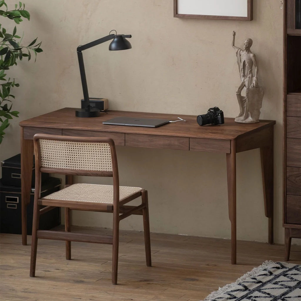 A minimalist solid wood desk with two drawers, curved legs and a smooth tabletop.