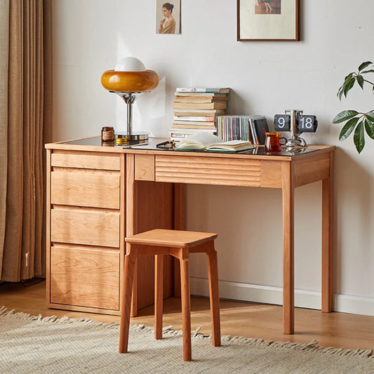 a natural cherry wood desk with tempered glass top, storage cabinet and drawers