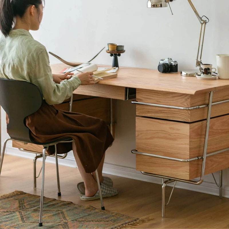 a natural wood desk with stainless steel frame and five drawers