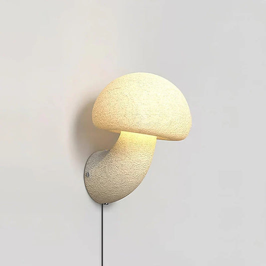 a white mushroom plug in wall lamp, emitting a soft glow