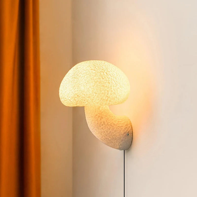 a white plug in wall sconce in a mushroom shape