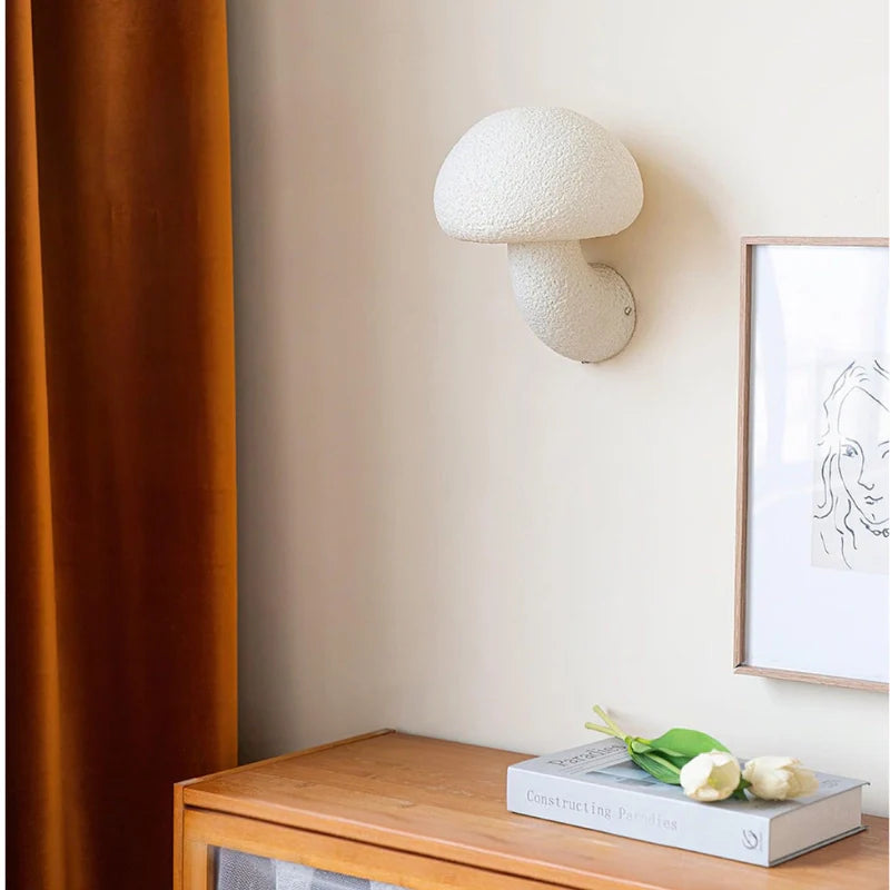 a white plug in wall lamp in a mushroom shape