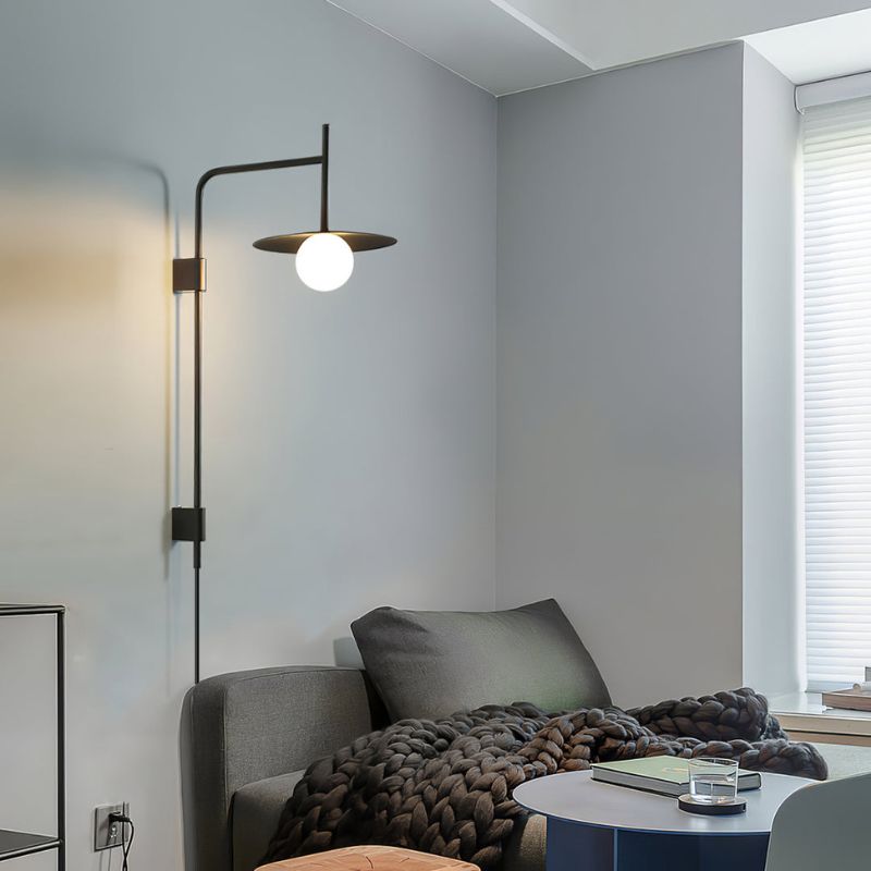 an illuminated plug in swing arm wall lamp in a modern living room