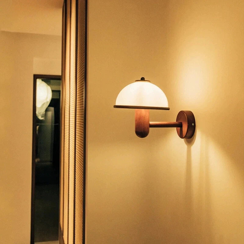 An illuminated mushroom shaped plug in Wall Lamp mounted by the hallway