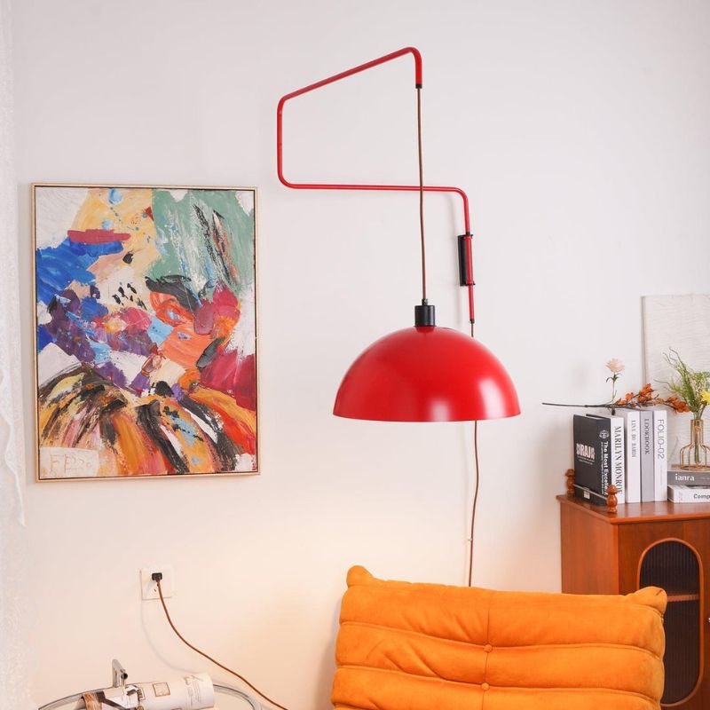 Red Plug in Wall Light with dome shade above a modern living space 