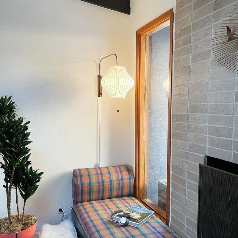 Pear Shaped plug in wall sconces variant illuminating a cozy reading nook