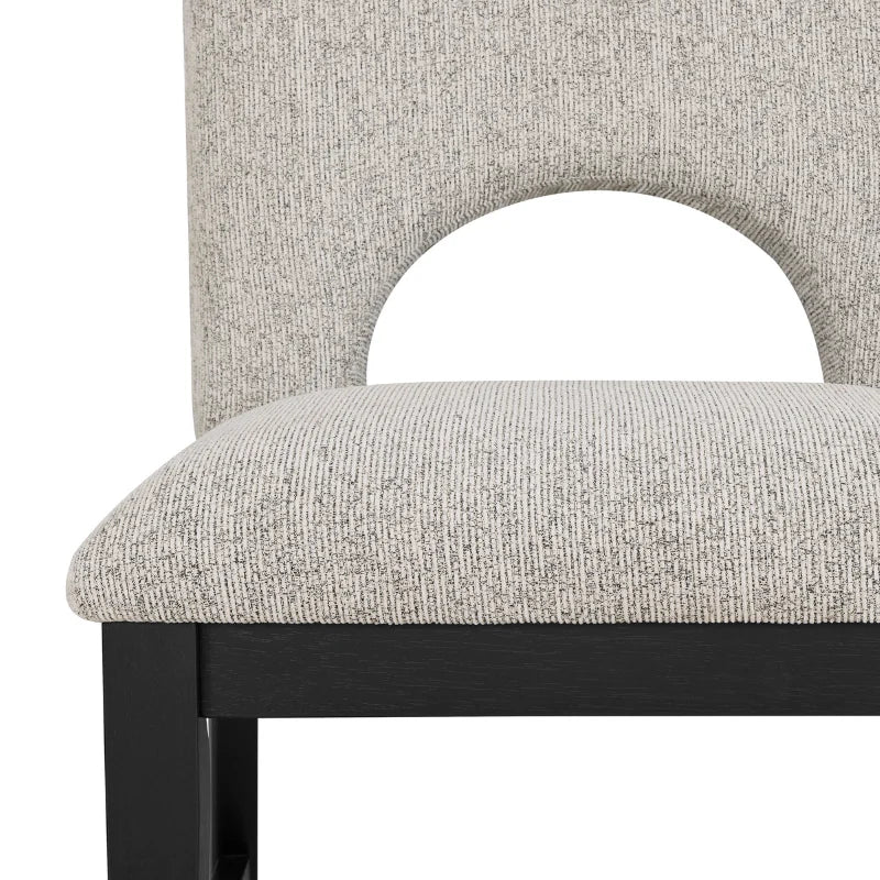 Close view of the upholstered dining chair of round wood dining table set