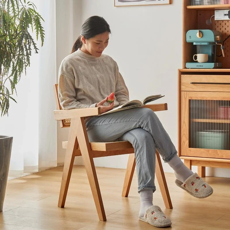 A Modern Rattan Dining Chair Offering Comfortable Seating and Arm Support.