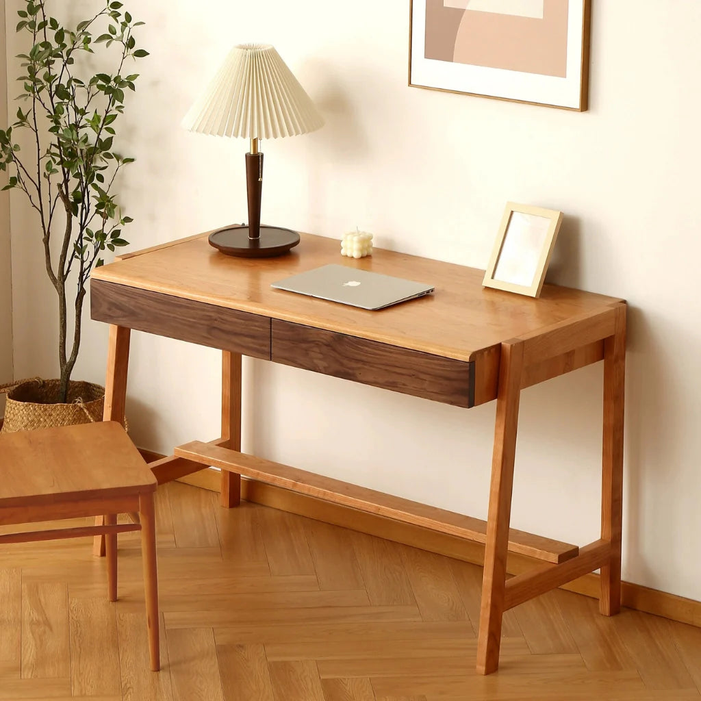 a cherry wood desk with two walnut-front drawers, showcasing a warm and stylish design for your workspace.