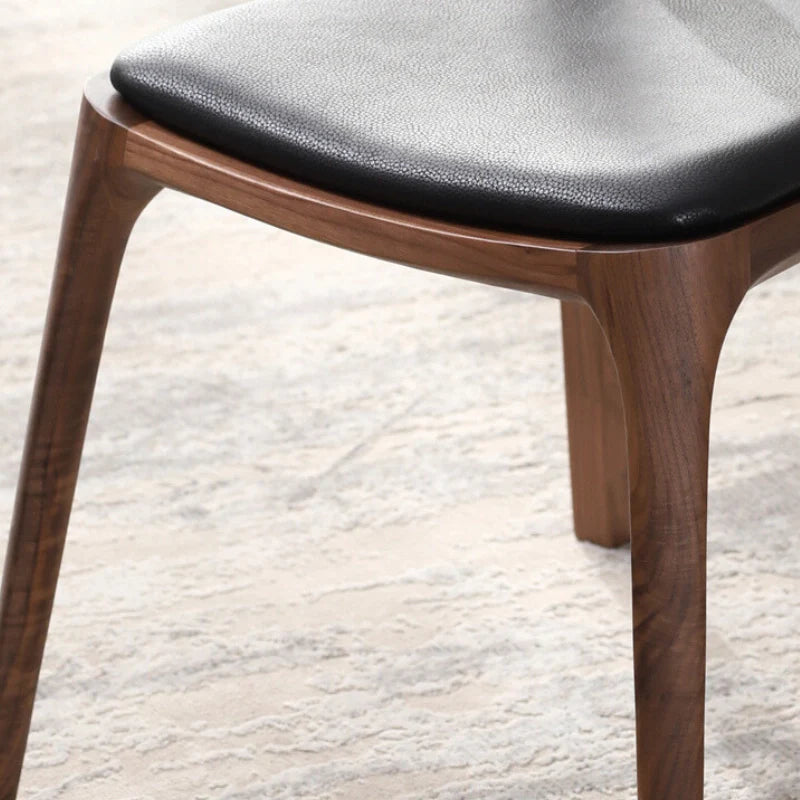 Wood and leather dining chair showing black leather seat