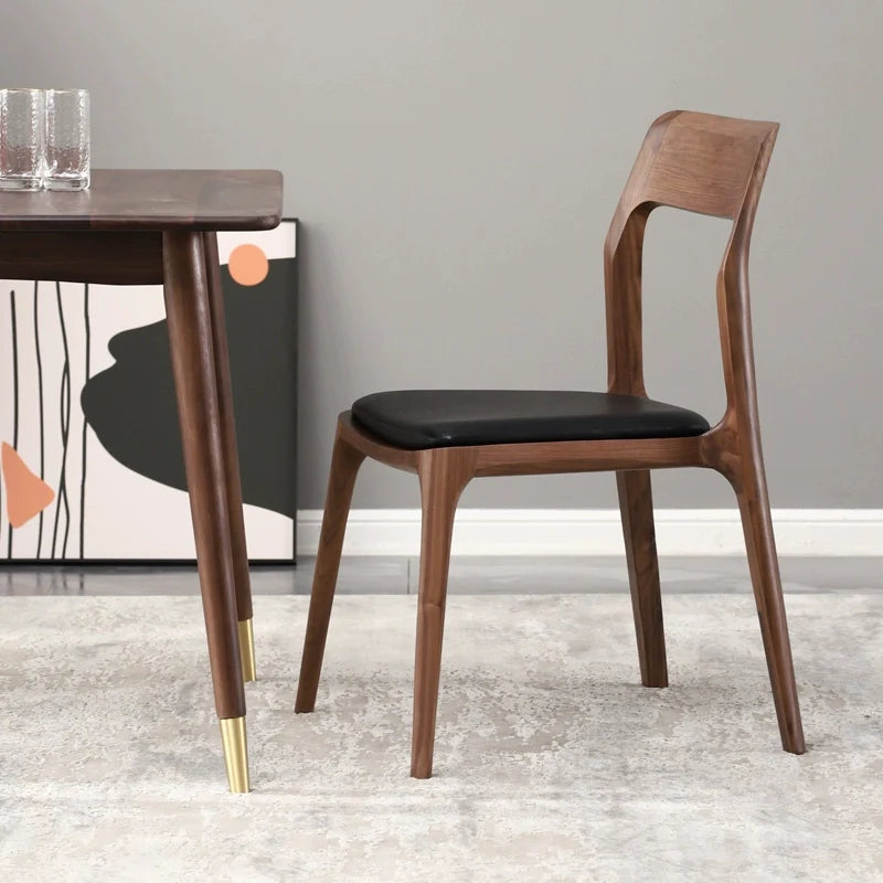 Wood dining chair by a dining table in a dining room setting