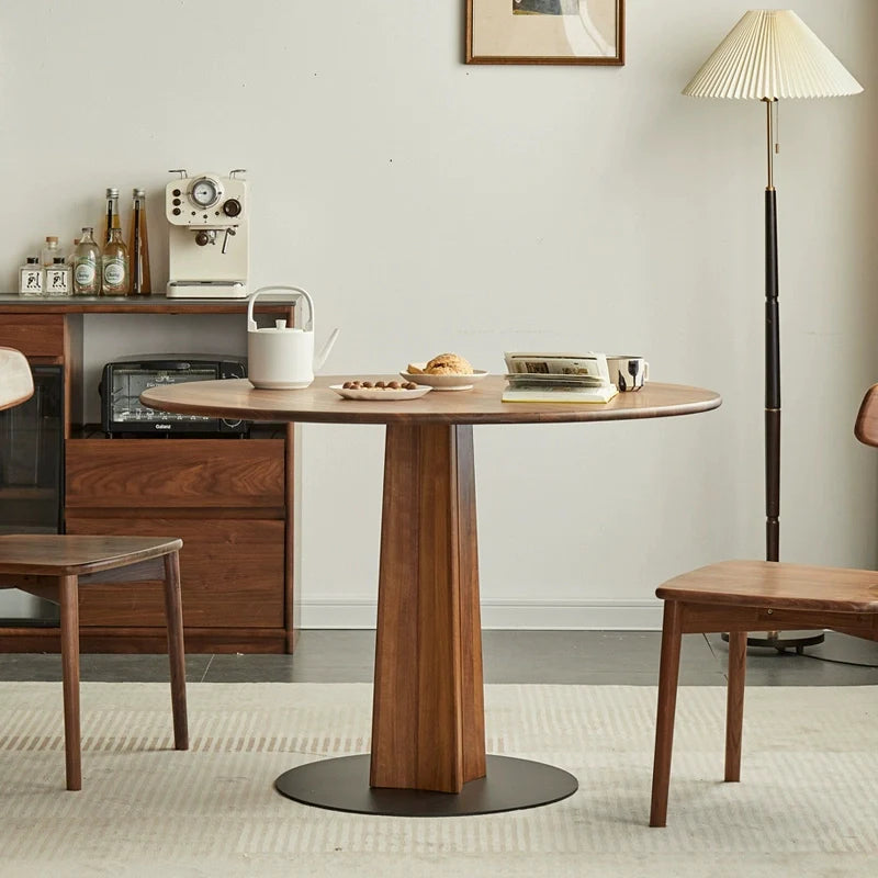 A Wood Pedestal Dining Table with matching dining chairs