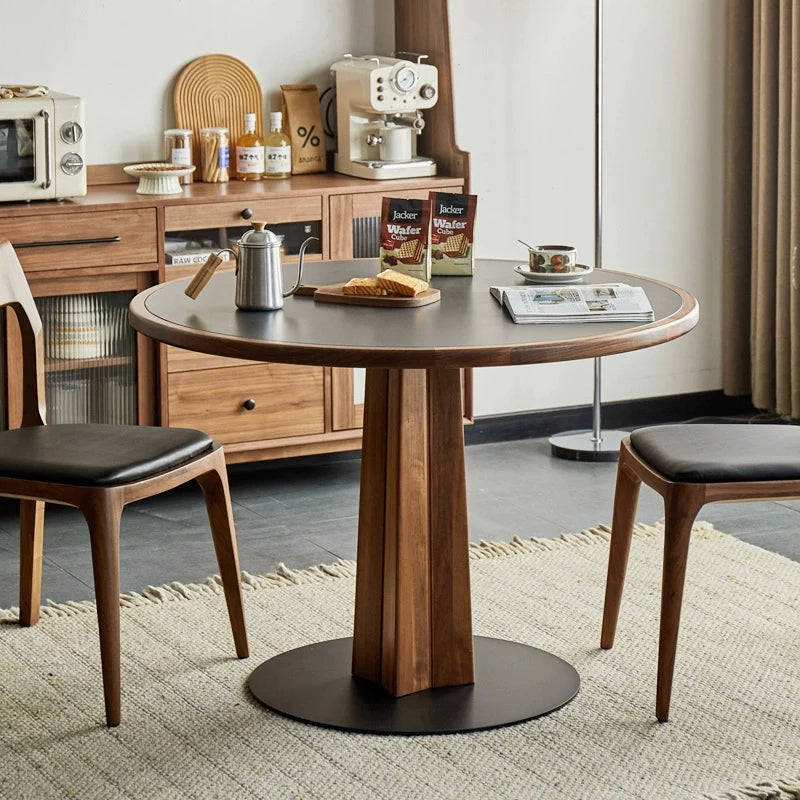 A Wood Pedestal Dining Table with Sintered Stone Top and Dining Chairs in a Modern Living Room Setting