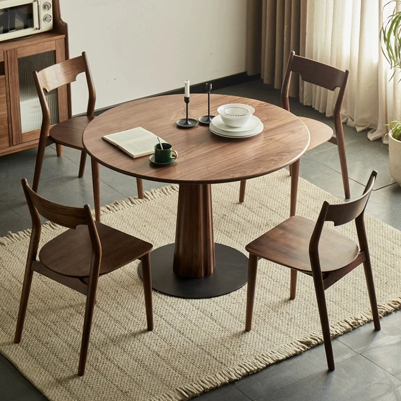 A Wood Pedestal Dining Table with Matching Wooden Dining Chairs