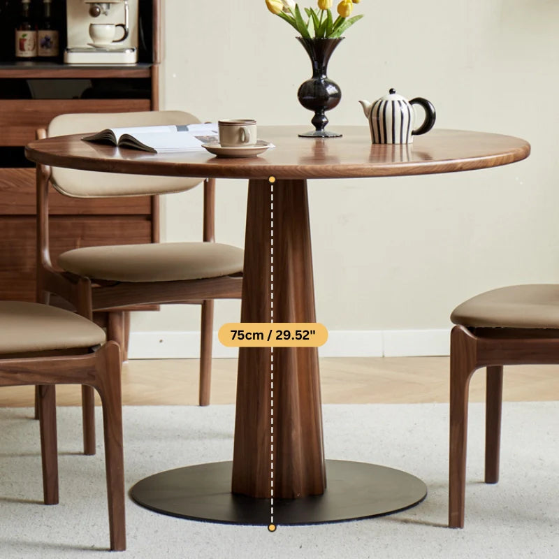 a solid wood pedestal dining table with a sturdy base