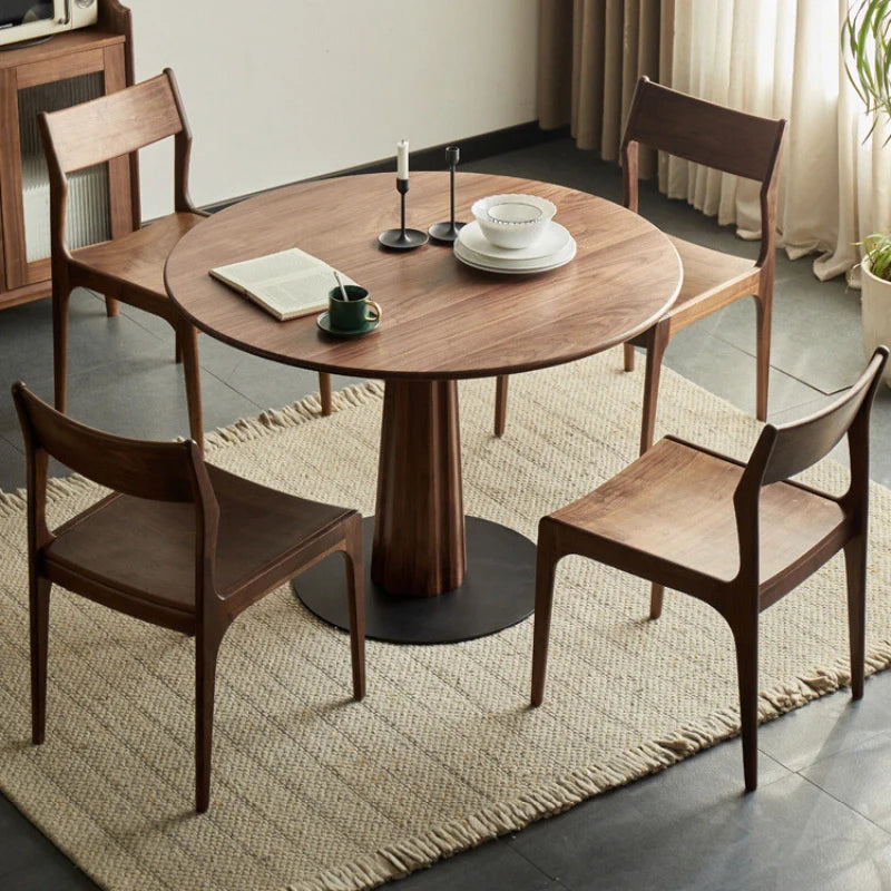 A Wood Pedestal Dining Table with matching dining chairs