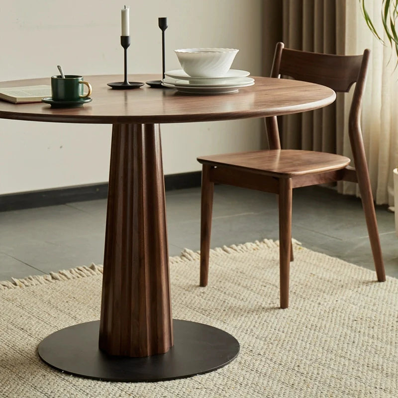 a round wooden pedestal dining table