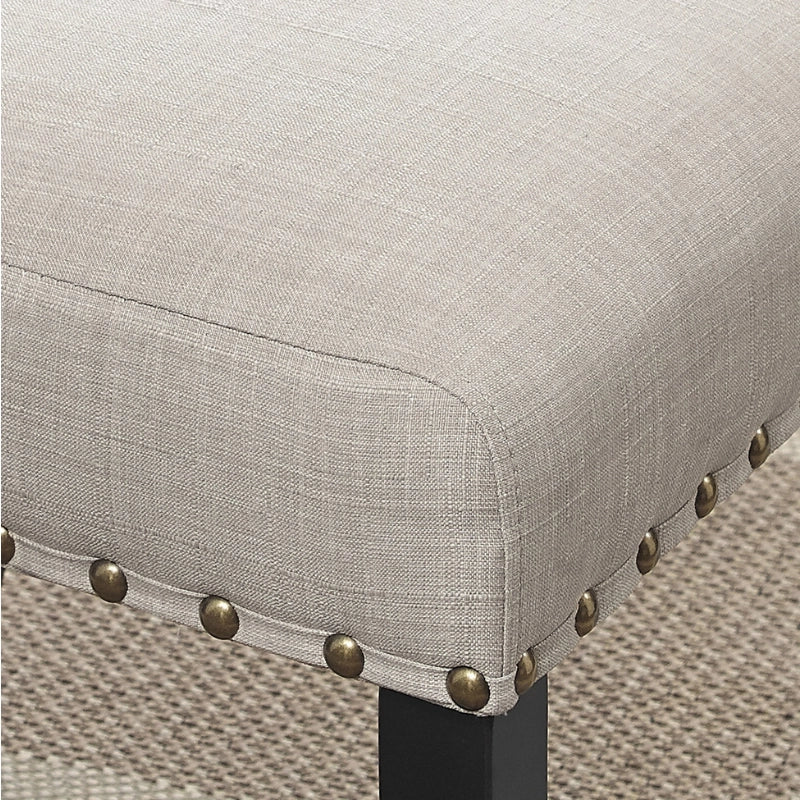 Up Close View of Nailhead Design of Tan Upholstered Wood Dining Chair