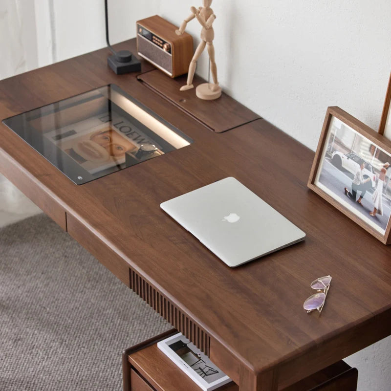 a walnut wood desk with tempered glass top and cable management