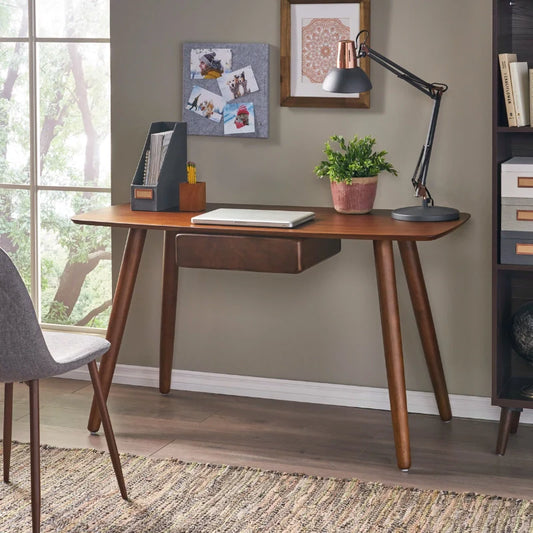 a wooden desk with drawer and tapered legs on a modern living area